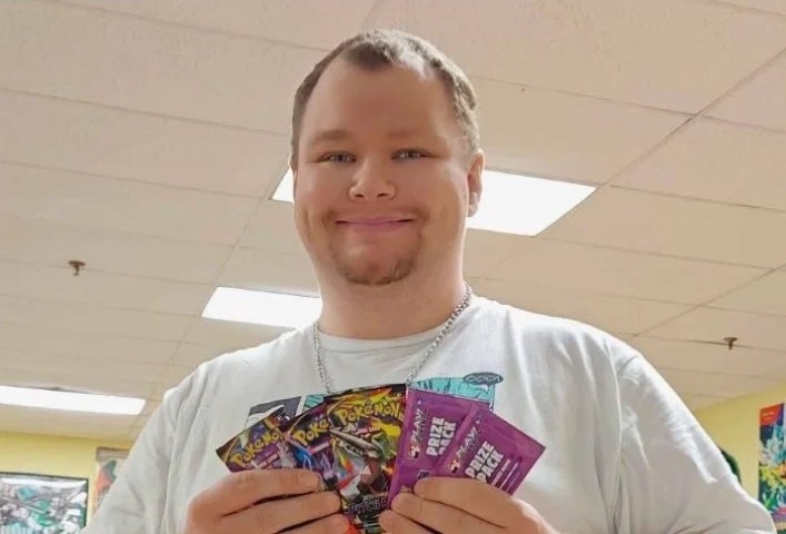 Jon holding Pokémon prize packs at the shop