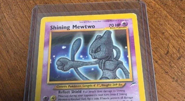 Vintage Shining Mewtwo Pokémon card in a protective sleeve